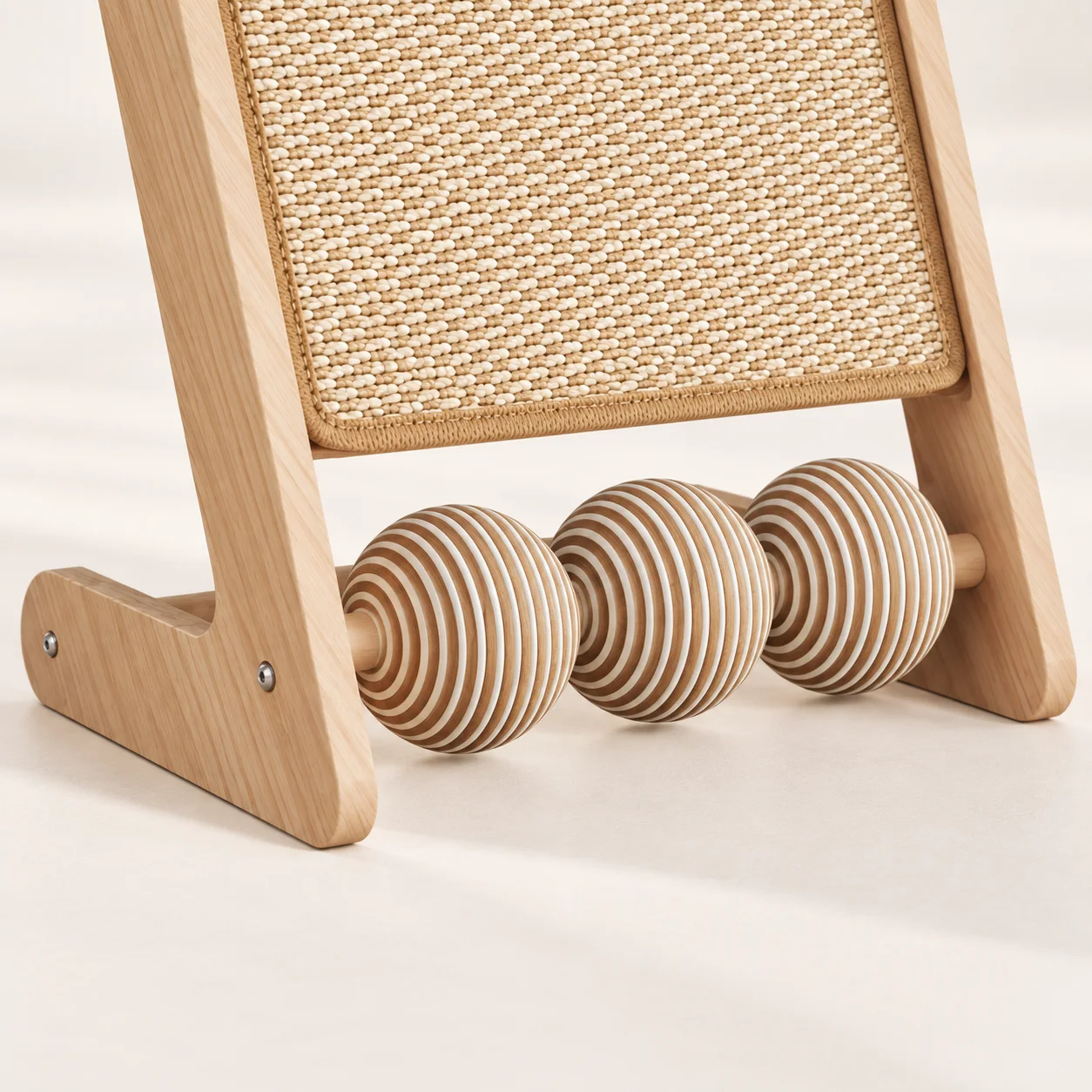 Three striped rollers and natural wood frame of a sisal scratcher